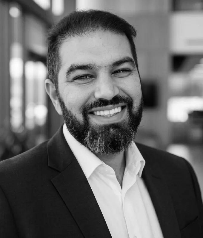 Lee Tango, founder of Tango AI Enablement, smiling in a suit jacket and open-necked shirt